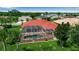 An aerial shot showcases this home's backyard with a screened-in pool and patio, plus a well-manicured lawn at 2148 Date Palm Way, Venice, FL 34292