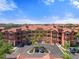 Aerial view showcasing building exteriors, lush greenery, and well-manicured parking areas at 2741 Via Cipriani # 935A, Clearwater, FL 33764