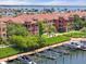 Picturesque view of waterfront residences, boat slips, and lush landscaping along the water's edge at 2741 Via Cipriani # 935A, Clearwater, FL 33764