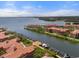 Stunning aerial view of waterfront homes, boat docks, and shimmering water on a clear day at 2741 Via Cipriani # 935A, Clearwater, FL 33764