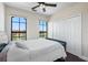 Comfortable bedroom featuring waterfront views, ceiling fan, and a closet with sliding doors at 2741 Via Cipriani # 935A, Clearwater, FL 33764