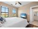 Cozy bedroom with dual windows, television, and an en-suite bathroom at 2741 Via Cipriani # 935A, Clearwater, FL 33764
