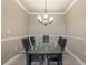 Formal dining area with modern chandelier and seating with glass top table, perfect for hosting gatherings at 2741 Via Cipriani # 935A, Clearwater, FL 33764