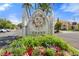 Grand entrance sign with colorful flowers and lush landscaping welcomes residents and guests to the community at 2741 Via Cipriani # 935A, Clearwater, FL 33764