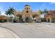 Elegant community entrance with a gate, clock tower, and lush palm trees at 2741 Via Cipriani # 935A, Clearwater, FL 33764