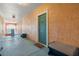 Entrance to a waterfront condo featuring a teal door, exterior lighting, welcome mat and benches at 2741 Via Cipriani # 935A, Clearwater, FL 33764