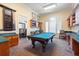 Well-lit game room featuring a billiards table, built-in shelving, and comfortable seating at 2741 Via Cipriani # 935A, Clearwater, FL 33764