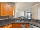 An open concept kitchen features granite countertops and opens to the living room and balcony at 2741 Via Cipriani # 935A, Clearwater, FL 33764