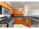 Kitchen featuring wooden cabinets, stainless steel appliances, granite countertops and tile floors at 2741 Via Cipriani # 935A, Clearwater, FL 33764
