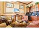 Elegant sitting room featuring comfortable armchairs, wet bar and refined decor at 2741 Via Cipriani # 935A, Clearwater, FL 33764