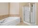Main bathroom featuring a shower, a soaking tub, and tile floors at 2741 Via Cipriani # 935A, Clearwater, FL 33764
