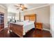 Main bedroom features wood floors, a ceiling fan, and a large bed at 2741 Via Cipriani # 935A, Clearwater, FL 33764
