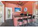 Outdoor kitchen features a granite countertop, sink, ceiling fan and TV overlooking landscaped exterior at 2741 Via Cipriani # 935A, Clearwater, FL 33764