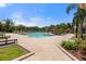 Beautiful community pool with plenty of lounge seating and lush tropical landscaping, perfect for relaxation at 2741 Via Cipriani # 935A, Clearwater, FL 33764