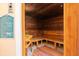 Inviting sauna room with wooden benches, paneling, and posted rules at 2741 Via Cipriani # 935A, Clearwater, FL 33764