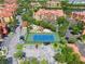 Aerial view of a community tennis court, parking lot, and residential buildings at 2741 Via Cipriani # 935A, Clearwater, FL 33764