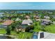 Aerial view of several large homes with screened in pools and a serene lake in the neighborhood at 303 Cockle Shell Loop, Apollo Beach, FL 33572