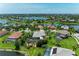 Scenic aerial shot of luxurious homes with screened pools in a lakeside community at 303 Cockle Shell Loop, Apollo Beach, FL 33572