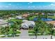 An aerial captures a residence framed by palm trees, with views of the serene community and landscaping at 303 Cockle Shell Loop, Apollo Beach, FL 33572