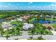 A beautiful aerial view of a neighborhood with lush landscaping and a serene pond at 303 Cockle Shell Loop, Apollo Beach, FL 33572