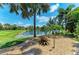Lush backyard landscape, water view, and stone features creates a peaceful outdoor living space at 303 Cockle Shell Loop, Apollo Beach, FL 33572