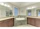 Luxurious bathroom featuring a soaking tub, granite countertops, and stylish fixtures at 303 Cockle Shell Loop, Apollo Beach, FL 33572