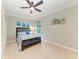 Bedroom featuring a queen bed with nautical bedding, blue decor, and a ceiling fan at 303 Cockle Shell Loop, Apollo Beach, FL 33572