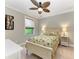 Charming bedroom with a ceiling fan and a window providing natural light at 303 Cockle Shell Loop, Apollo Beach, FL 33572