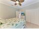 Comfortable bedroom equipped with a ceiling fan and ample closet space at 303 Cockle Shell Loop, Apollo Beach, FL 33572