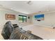 The bonus room is carpeted, and has large windows with a large screen TV for watching movies at 303 Cockle Shell Loop, Apollo Beach, FL 33572
