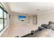 A bonus room with carpet, and a large screen TV for watching movies at 303 Cockle Shell Loop, Apollo Beach, FL 33572