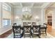 Formal dining room featuring a modern chandelier and neutral decor at 303 Cockle Shell Loop, Apollo Beach, FL 33572