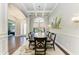 Elegant dining room featuring coffered ceilings, chandelier, and an open view to the front entry at 303 Cockle Shell Loop, Apollo Beach, FL 33572
