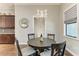 Cozy breakfast nook with a chandelier and views into the kitchen area at 303 Cockle Shell Loop, Apollo Beach, FL 33572