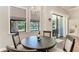 Bright breakfast nook with a chandelier and views of the pool at 303 Cockle Shell Loop, Apollo Beach, FL 33572