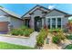 Charming entryway with stone accents and vibrant landscaping at 303 Cockle Shell Loop, Apollo Beach, FL 33572