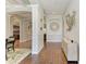 Stylish foyer with decorative molding, hardwood floors, and a view into other living spaces at 303 Cockle Shell Loop, Apollo Beach, FL 33572