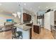 Open-concept kitchen with dark wood cabinets, granite countertops, and a convenient breakfast bar at 303 Cockle Shell Loop, Apollo Beach, FL 33572