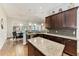 Spacious kitchen featuring a center island, granite countertops, and dark wood cabinetry at 303 Cockle Shell Loop, Apollo Beach, FL 33572