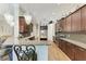 Bright kitchen showcasing dark wood cabinets, granite countertops, and stainless steel appliances at 303 Cockle Shell Loop, Apollo Beach, FL 33572