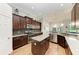 Well-equipped kitchen with granite countertops, dark wood cabinets, and a functional center island at 303 Cockle Shell Loop, Apollo Beach, FL 33572
