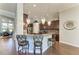 Elegant kitchen featuring dark wood cabinets, granite countertops, and decorative pendant lighting at 303 Cockle Shell Loop, Apollo Beach, FL 33572