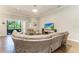 Spacious living room with a large sectional sofa and sliding glass doors to the outdoors at 303 Cockle Shell Loop, Apollo Beach, FL 33572