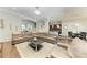 Expansive living room featuring a plush sectional and views into the dining and kitchen areas at 303 Cockle Shell Loop, Apollo Beach, FL 33572