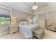 Inviting main bedroom with tray ceilings, complemented by soft lighting and a relaxing ambiance at 303 Cockle Shell Loop, Apollo Beach, FL 33572