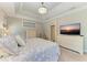 Serene main bedroom with a tray ceiling, neutral tones, and comfortable furnishings at 303 Cockle Shell Loop, Apollo Beach, FL 33572