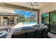 The outdoor seating area has comfortable seating and an outdoor kitchen nearby at 303 Cockle Shell Loop, Apollo Beach, FL 33572