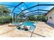The pool has built-in lounge chairs and a hot tub, with views of the lake at 303 Cockle Shell Loop, Apollo Beach, FL 33572