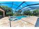 The pool has built-in lounge chairs and a hot tub, with views of the lake at 303 Cockle Shell Loop, Apollo Beach, FL 33572