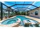 The pool has built-in lounge chairs and a hot tub, with views of the lake at 303 Cockle Shell Loop, Apollo Beach, FL 33572